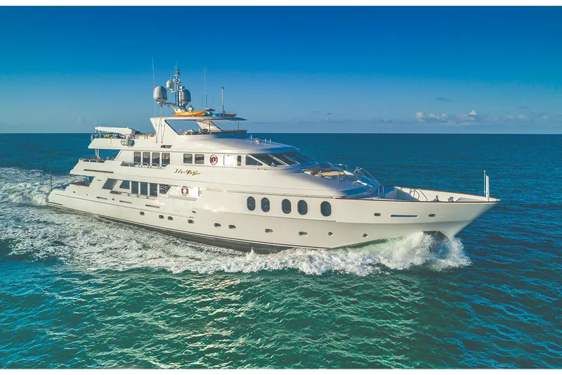 The Image of Luxurious 2002 Christensen Tri Deck yacht cruising on open sea under clear blue sky. - 0