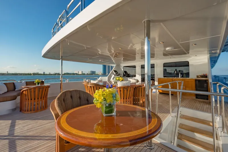 Slide: The Image of Luxurious 2002 Christensen Tri Deck yacht with elegant outdoor seating and ocean view. - 10