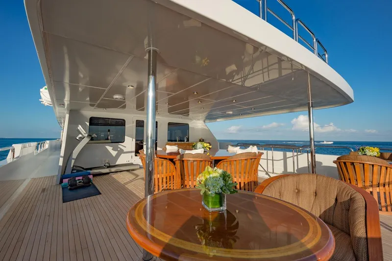 Slide: The Image of Luxurious 2002 Christensen Tri Deck yacht with elegant outdoor seating and ocean view. - 12
