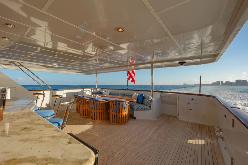 Slide: The Image of Luxurious 2002 Christensen Tri Deck yacht with elegant outdoor seating and ocean view. - 14