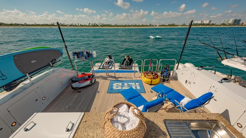 Slide: The Image of Luxurious 2002 Christensen Tri Deck yacht deck with lounge chairs, water sports gear, and ocean view. - 16