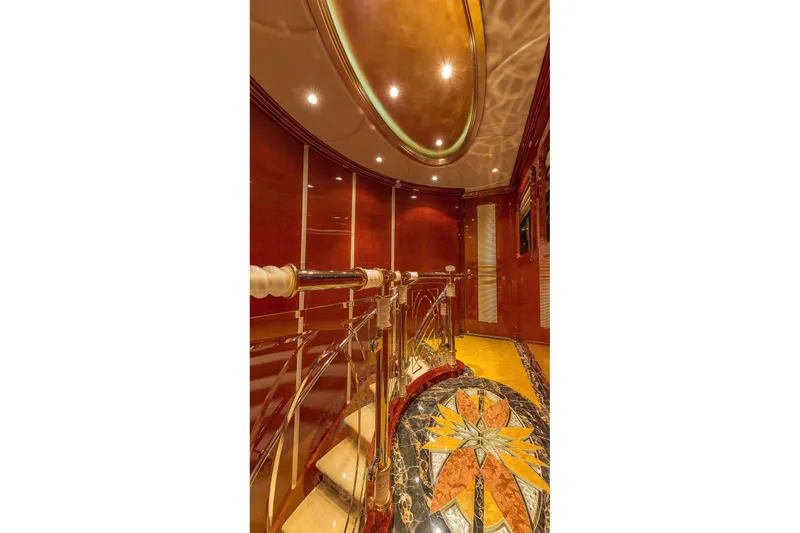 Slide: The Image of Luxurious interior of 2002 Christensen Tri Deck yacht with elegant staircase and intricate flooring design. - 26