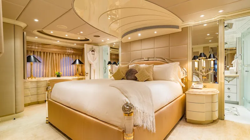 Slide: The Image of Luxurious bedroom on 2002 Christensen Tri Deck yacht with elegant decor and ambient lighting. - 34