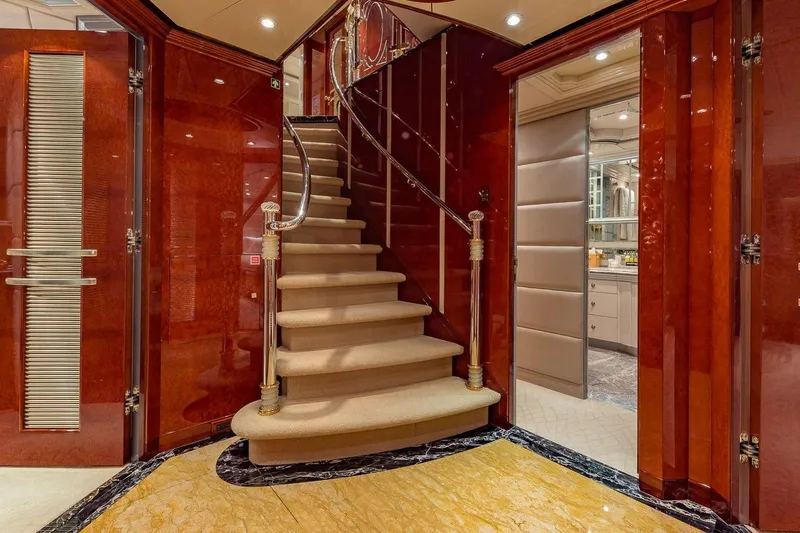 Slide: The Image of Luxurious interior of 2002 Christensen Tri Deck yacht with elegant staircase and polished wood finishes. - 39