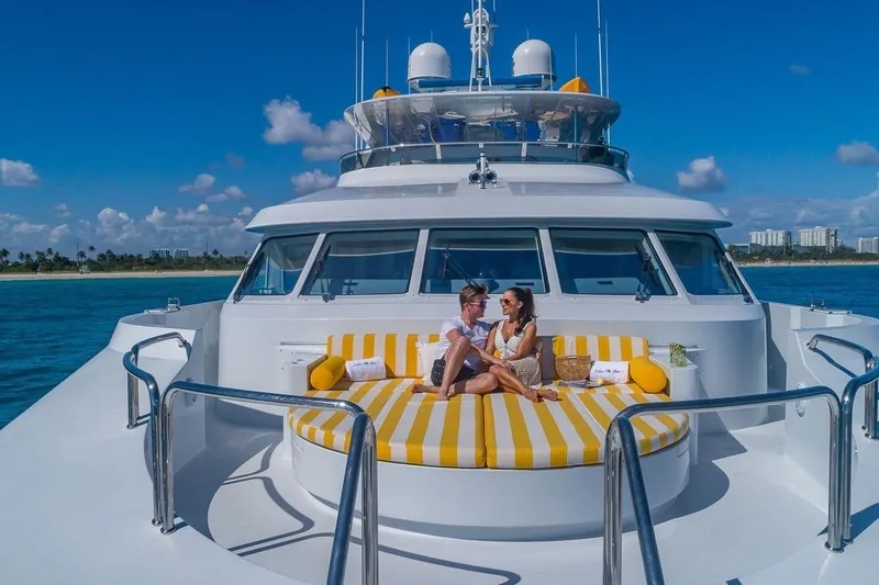 Slide: The Image of Couple relaxing on 2002 Christensen Tri Deck yacht with striped cushions, ocean view. - 4