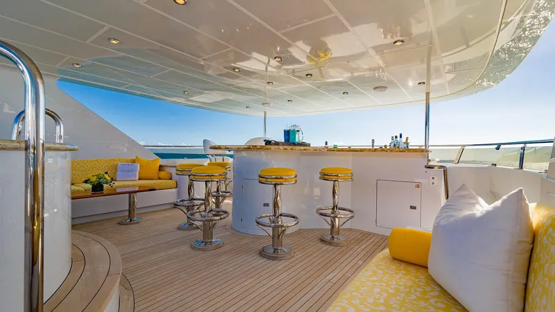 Slide: The Image of Luxurious 2002 Christensen Tri Deck yacht with elegant outdoor bar and seating area. - 7