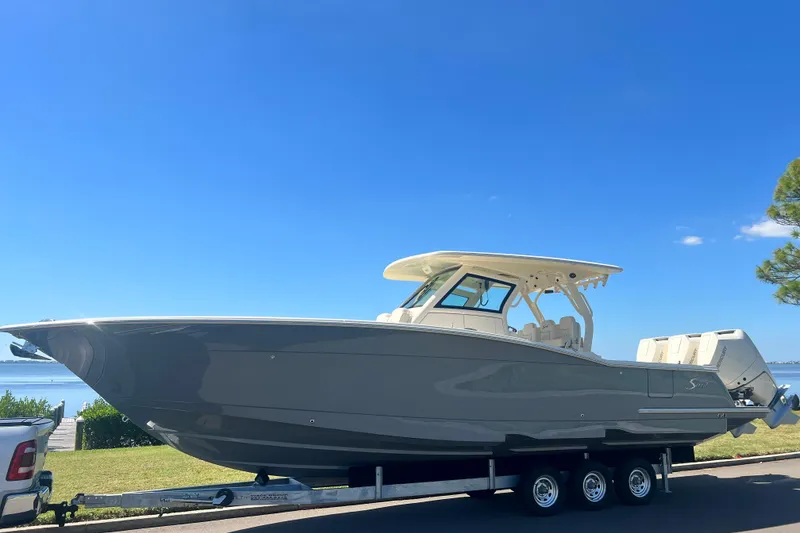 Slide: The Image of 2026 Scout 357 LXF boat on water with city skyline background. - 1