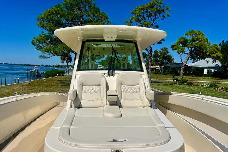 Slide: The Image of Interior view of 2026 Scout 357 LXF boat with navigation system and scenic waterfront. - 11