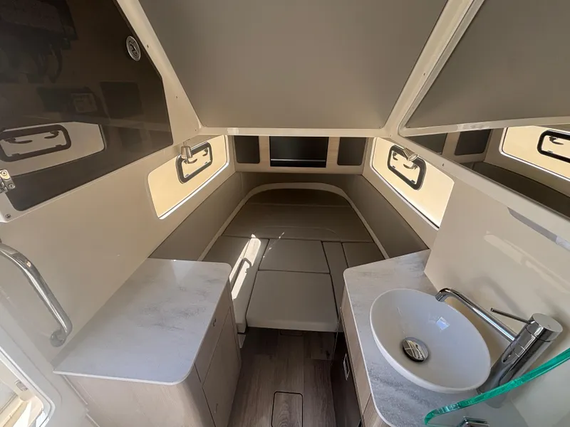 Slide: The Image of 2025 Scout 357 LXF boat deck with seating and storage compartments. - 14