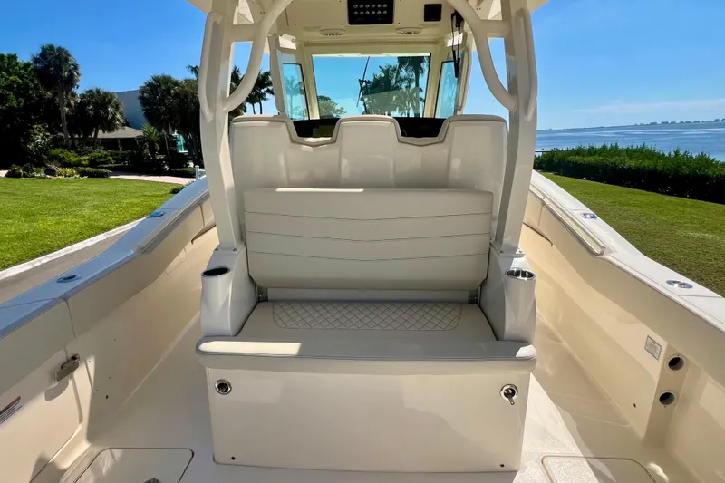 Slide: The Image of 2025 Scout 357 LXF boat with open storage compartments, docked in a marina. - 16