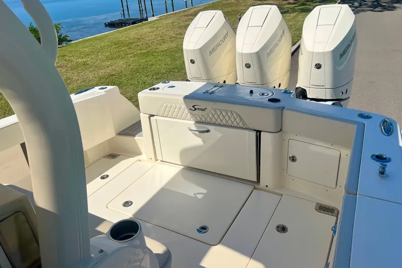 Slide: The Image of 2026 Scout 357 LXF boat interior with seating, overlooking a scenic waterfront. - 22
