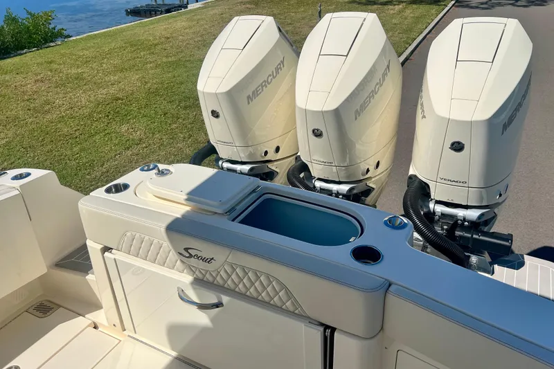 Slide: The Image of 2025 Scout 357 LXF boat seating area with cup holders and storage. - 23