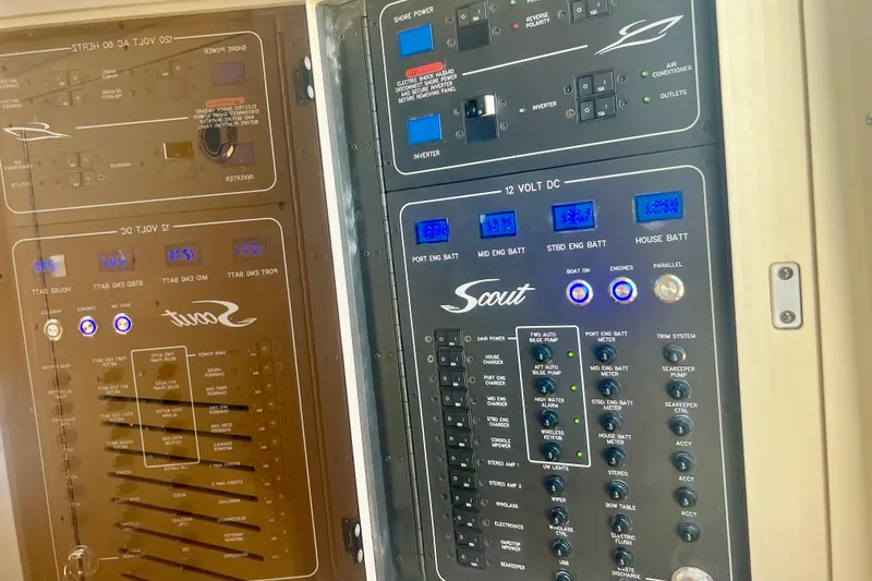 Slide: The Image of 2026 Scout 357 LXF boat with triple Mercury Verado engines, docked by the water. - 29