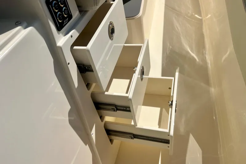 Slide: The Image of Open storage compartment on 2025 Scout 357 LXF boat, showcasing interior features. - 33