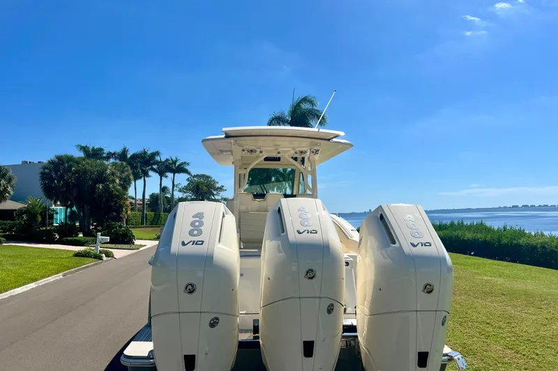 Slide: The Image of 2026 Scout 357 LXF boat on calm water under a clear blue sky. - 4