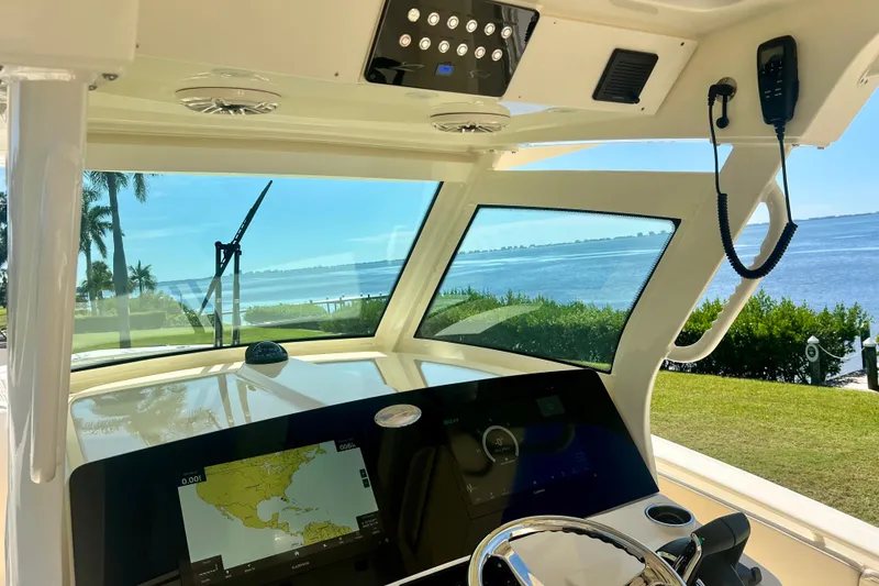 Slide: The Image of 2026 Scout 357 LXF boat on calm blue water under a clear sky. - 5