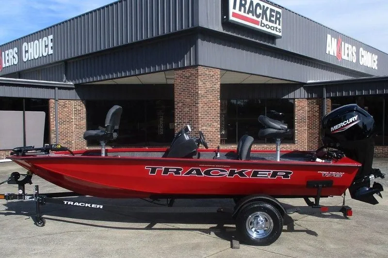 The Image of 2026 Tracker Pro Team 175 boat displayed outside dealership, featuring Mercury engine. - 1