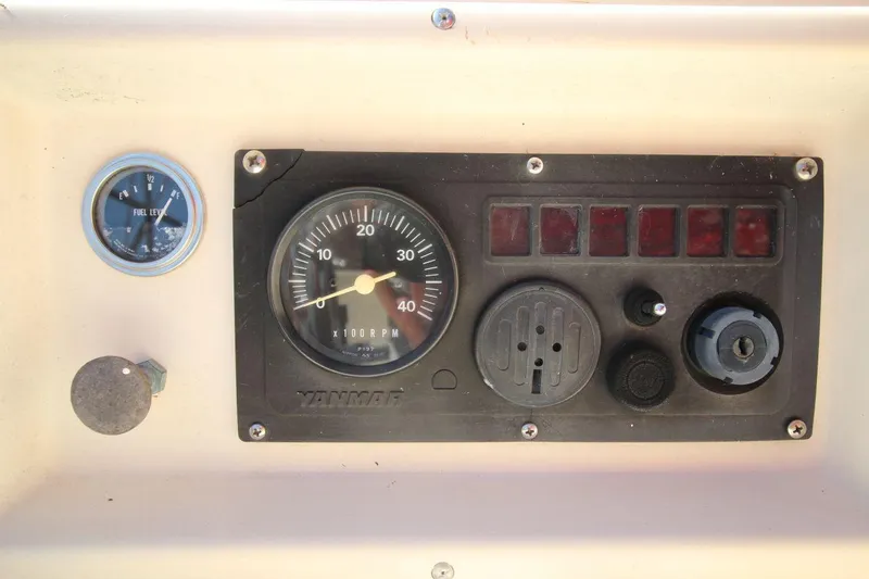 Slide: The Image of Control panel of a 1990 Island Packet 27 sailboat with fuel gauge and RPM meter. - 10
