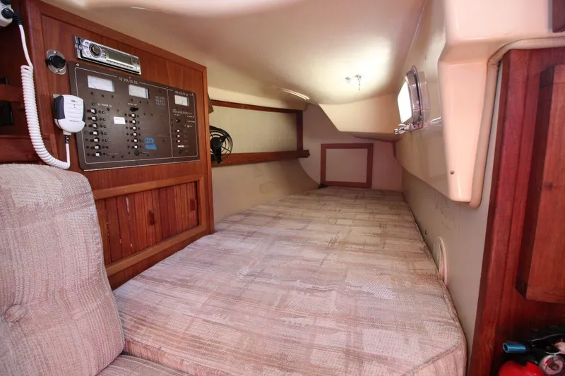 Slide: The Image of Interior cabin of 1990 Island Packet 27 sailboat with control panel and cozy sleeping area. - 16