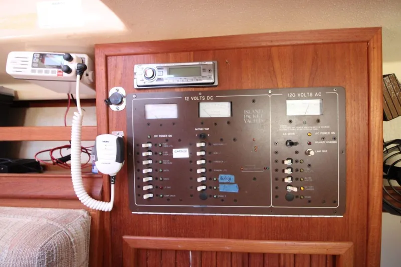 Slide: The Image of Electrical control panel on a 1990 Island Packet 27 sailboat, featuring 12V and 120V systems. - 17