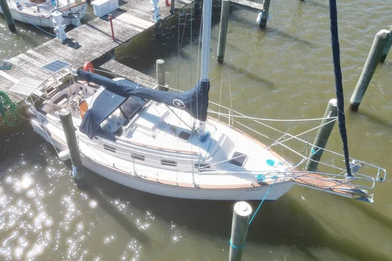 Slide: The Image of 1990 Island Packet 27 sailboat docked at marina, aerial view. - 3