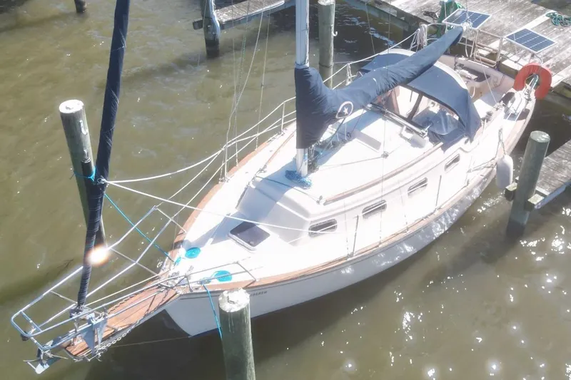 Slide: The Image of 1990 Island Packet 27 sailboat docked at marina, aerial view. - 4