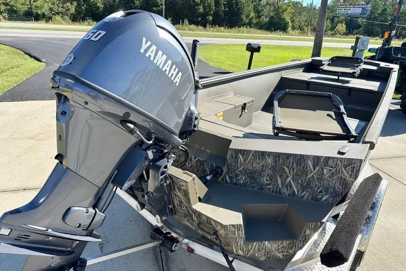 Slide: The Image of 2026 Thor 1754 Timber Hammer boat with Yamaha outboard motor, parked on a trailer. - 5