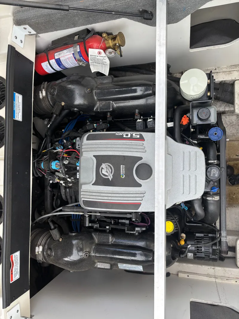 Slide: The Image of Engine compartment of 2010 Sea Ray 210 SL SS boat with visible fire extinguisher. - 11