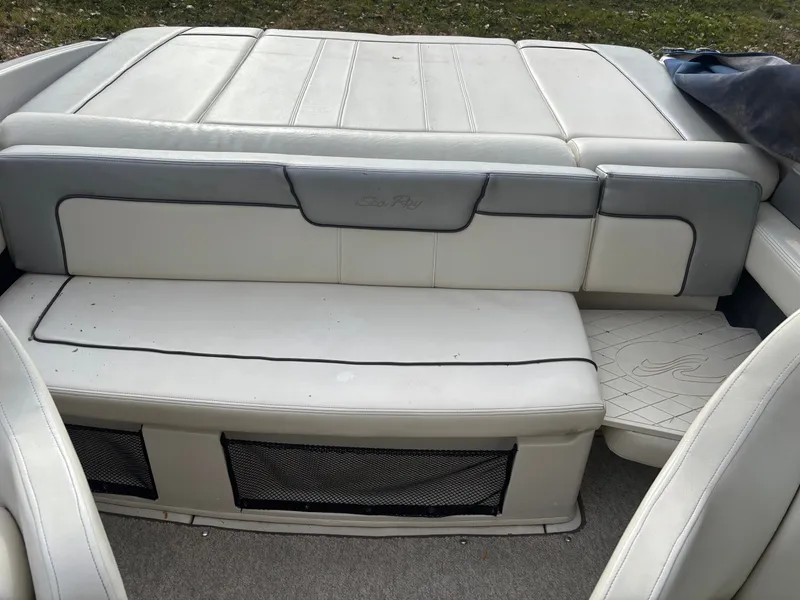 Slide: The Image of Interior seating of a 2010 Sea Ray 210 SL SS boat, featuring white and gray upholstery. - 3