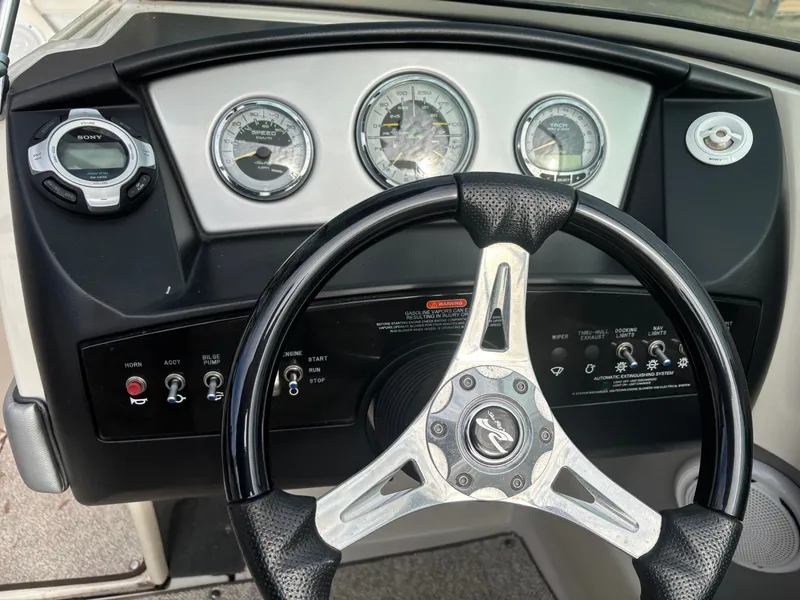 Slide: The Image of Steering wheel and dashboard of 2010 Sea Ray 210 SL SS boat with gauges and controls. - 4