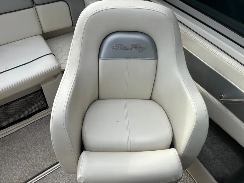 Slide: The Image of White leather seat in a 2010 Sea Ray 210 SL SS boat interior. - 6