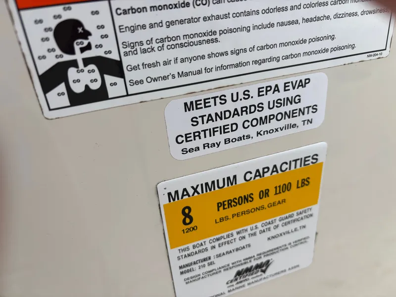 Slide: The Image of Sea Ray 210 SL SS 2010 boat capacity and EPA compliance labels. - 7