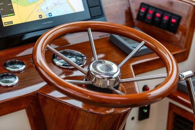 Slide: The Image of Steering wheel of 2004 Hinckley Picnic Boat EP with navigation controls and gauges. - 10