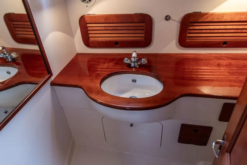 Slide: The Image of Luxurious wooden vanity in 2004 Hinckley Picnic Boat EP bathroom. - 23