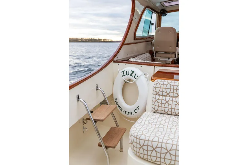 Slide: The Image of 2004 Hinckley Picnic Boat EP interior with patterned seating and life preserver. - 9