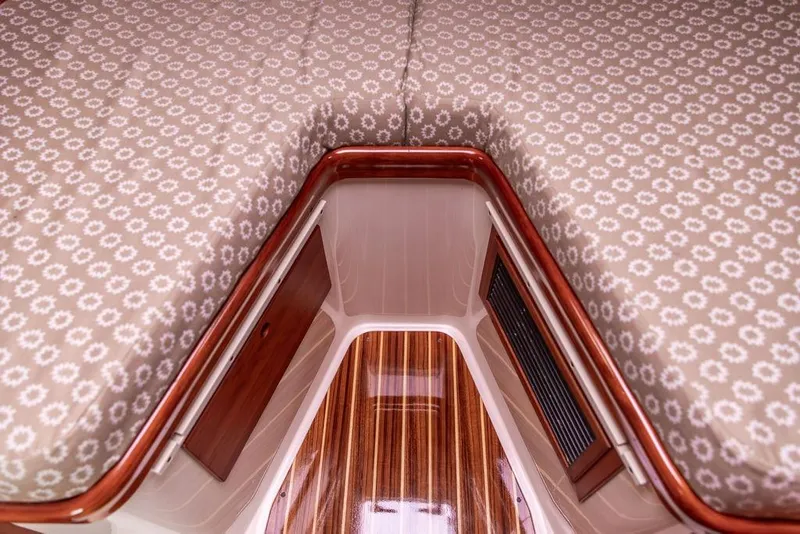 Slide: The Image of Interior of 2004 Hinckley Picnic Boat EP with patterned upholstery and wooden flooring. - 22