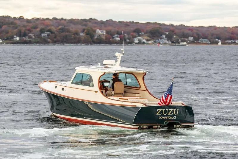 Slide: The Image of 2004 Hinckley Picnic Boat EP cruising on a scenic lake with autumn foliage. - 27
