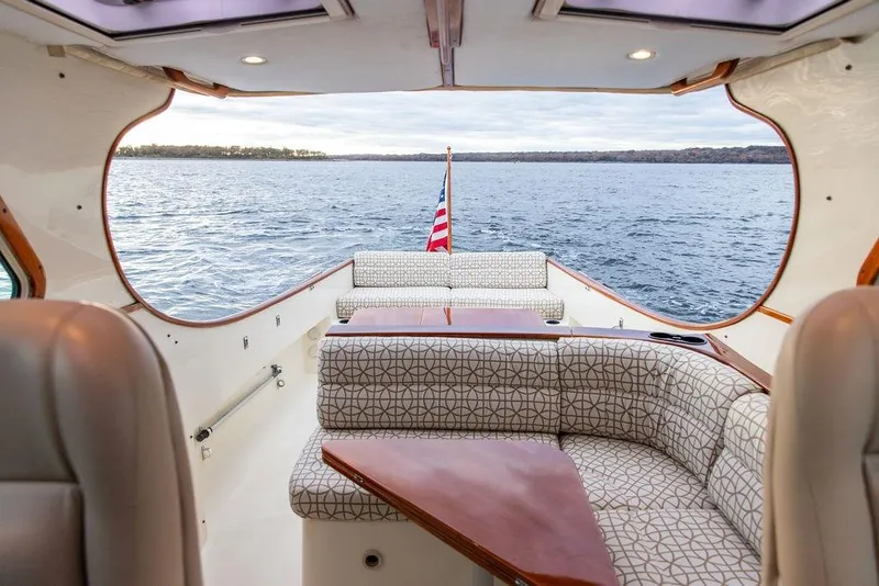 Slide: The Image of 2004 Hinckley Picnic Boat EP interior with elegant seating and scenic water view. - 6