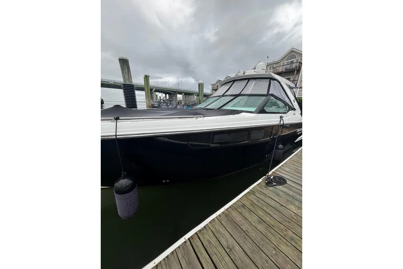 Slide: The Image of 2019 Monterey 378 Super Express boat docked at marina under cloudy sky. - 10