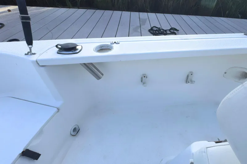 Slide: The Image of 2008 Trophy 1703 Center Console boat interior near dock, showing clean white deck. - 8