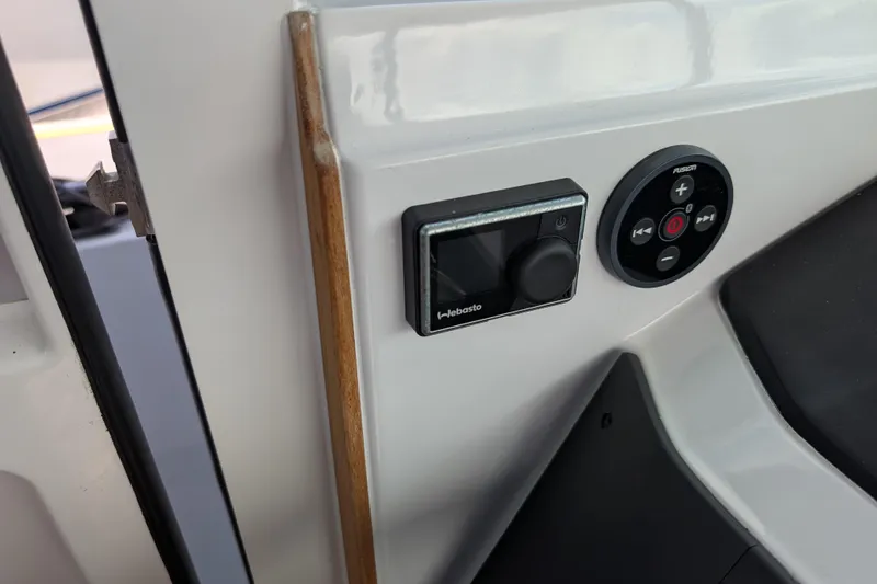Slide: The Image of Control panel on 2019 Axopar 28 CABIN boat, featuring Webasto and Fusion systems. - 31