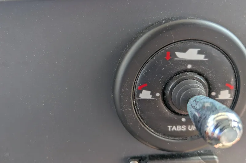 Slide: The Image of Control knob on 2019 Axopar 28 CABIN boat dashboard, labeled "TABS UP." - 35