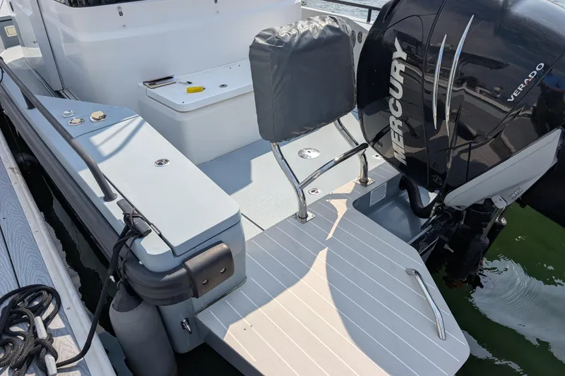 Slide: The Image of 2019 Axopar 28 CABIN boat with Mercury Verado engine at dockside. - 52