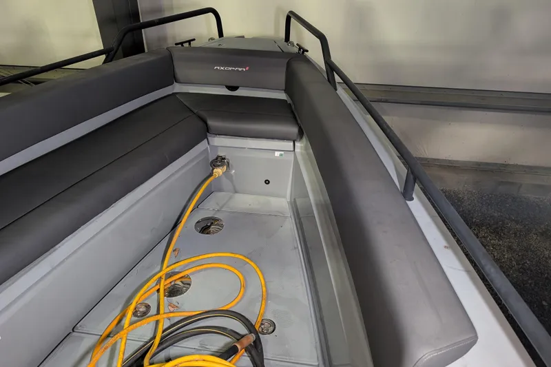 Slide: The Image of 2019 Axopar 28 Cabin interior with seating and electrical cables. - 49