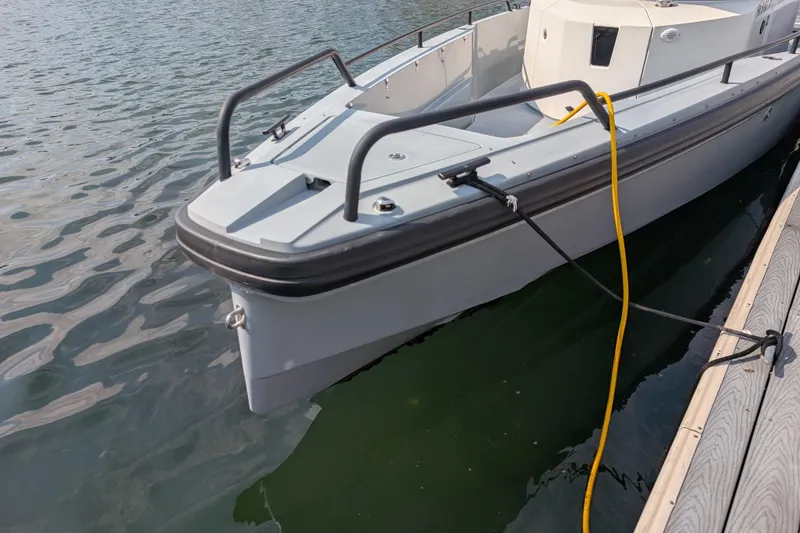 Slide: The Image of 2019 Axopar 28 CABIN boat docked on calm water. - 58