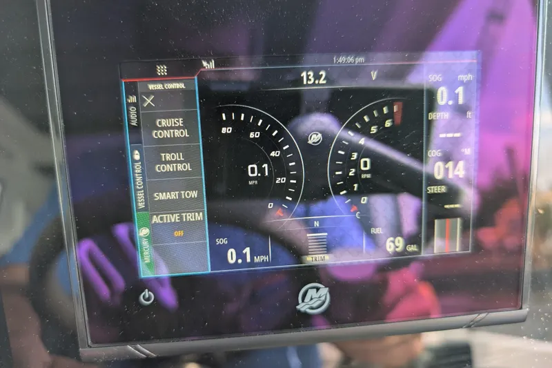 Slide: The Image of Dashboard of 2019 Axopar 28 CABIN boat showing speed, fuel, and control settings. - 28