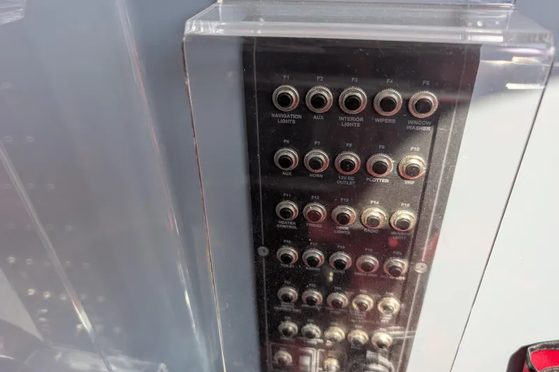 Slide: The Image of Control panel of a 2019 Axopar 28 CABIN boat with labeled switches. - 33