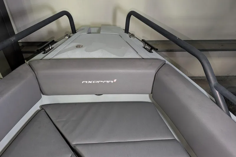 Slide: The Image of 2019 Axopar 28 Cabin boat interior with gray seating and railing. - 48