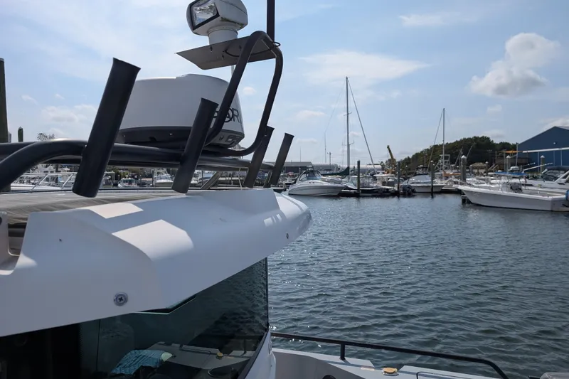 Slide: The Image of 2019 Axopar 28 CABIN boat docked in a marina with other vessels. - 6