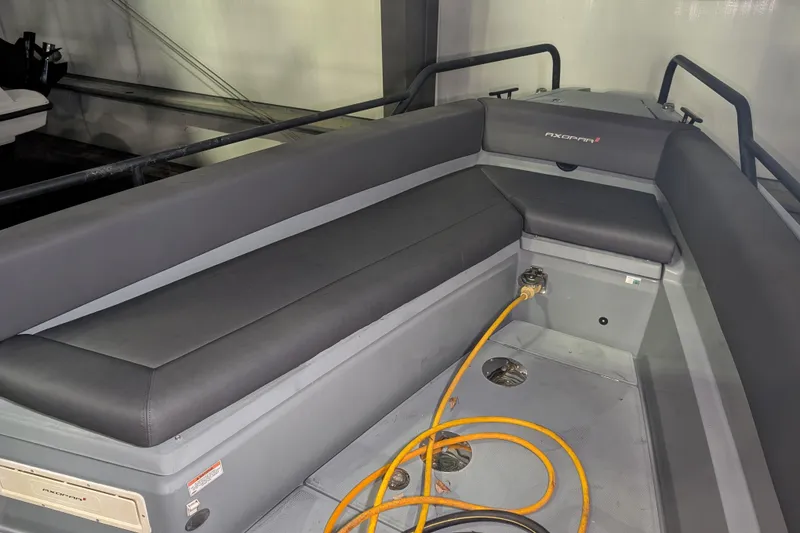 Slide: The Image of 2019 Axopar 28 Cabin interior with gray seating and orange cable. - 50